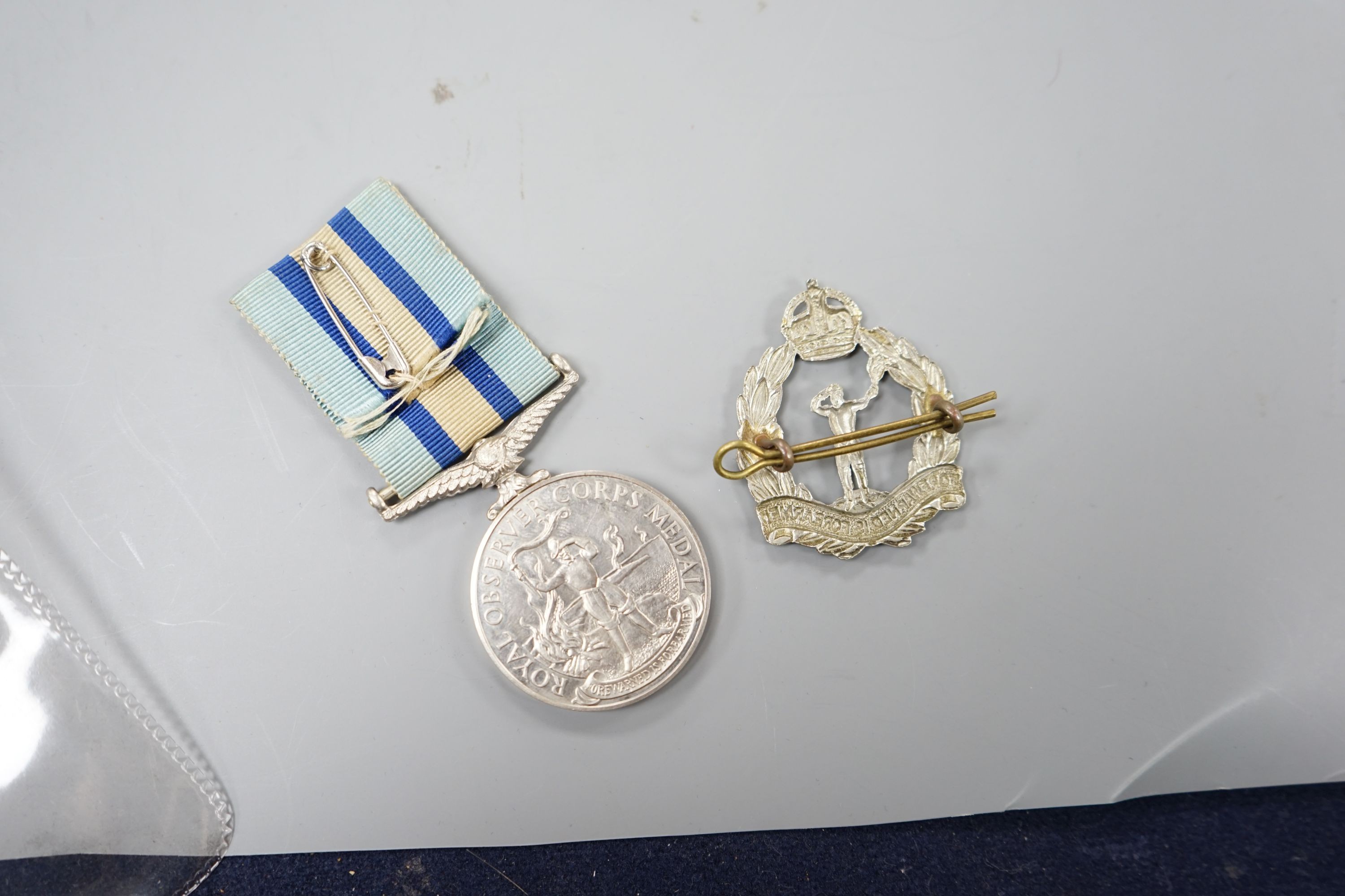 A QEII Royal Observer Corps Medal to 'CHIEF OBSERVER J. OSBORNE’ and a cap badge